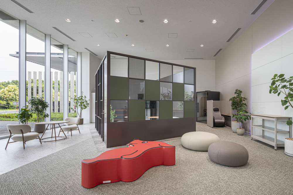 落ち着いた色のカーペット、ソファ、植物を設置